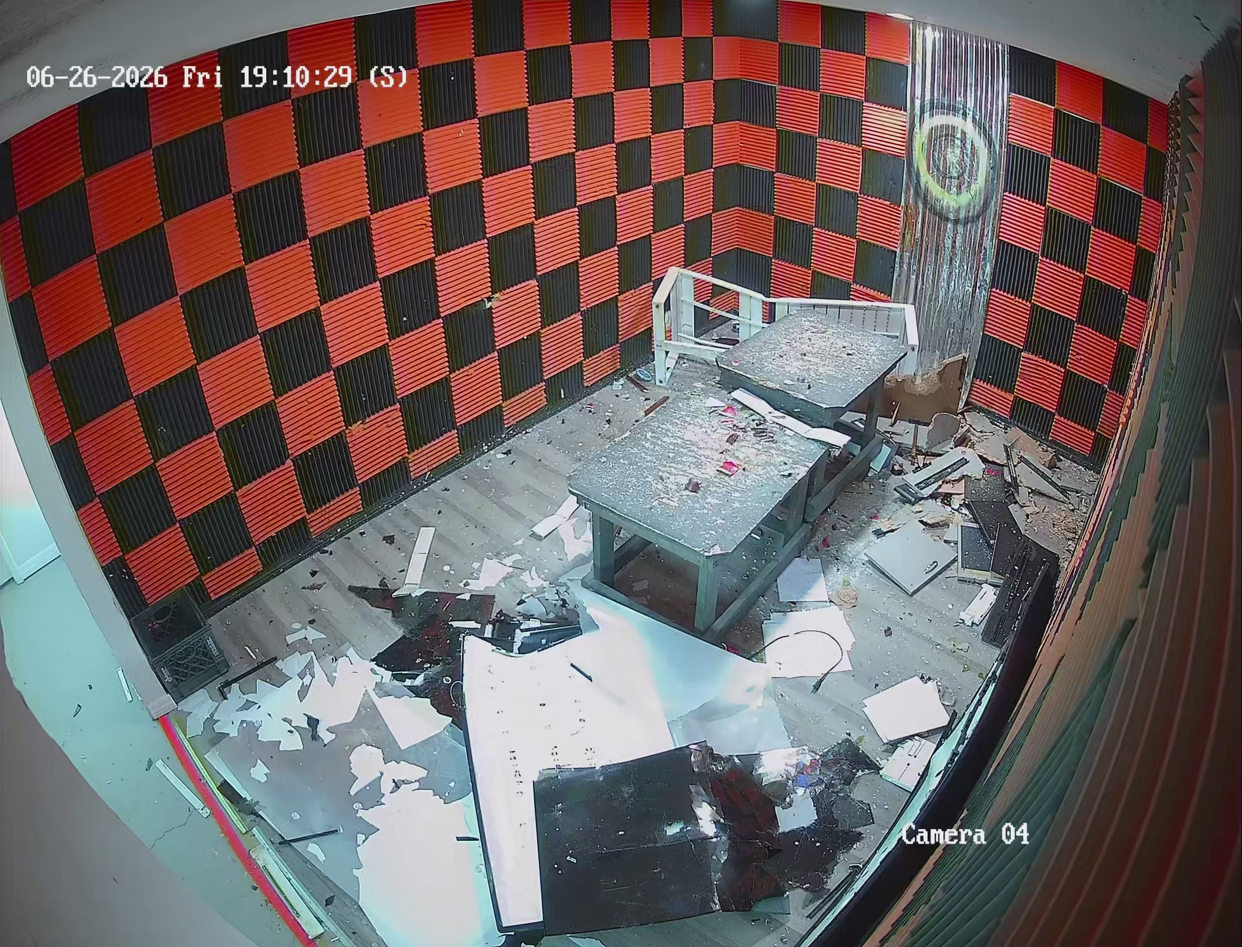 Security camera view of smash room aftermath in Crash Out Rage Rooms Florida location — debris and broken electronics covering the floor